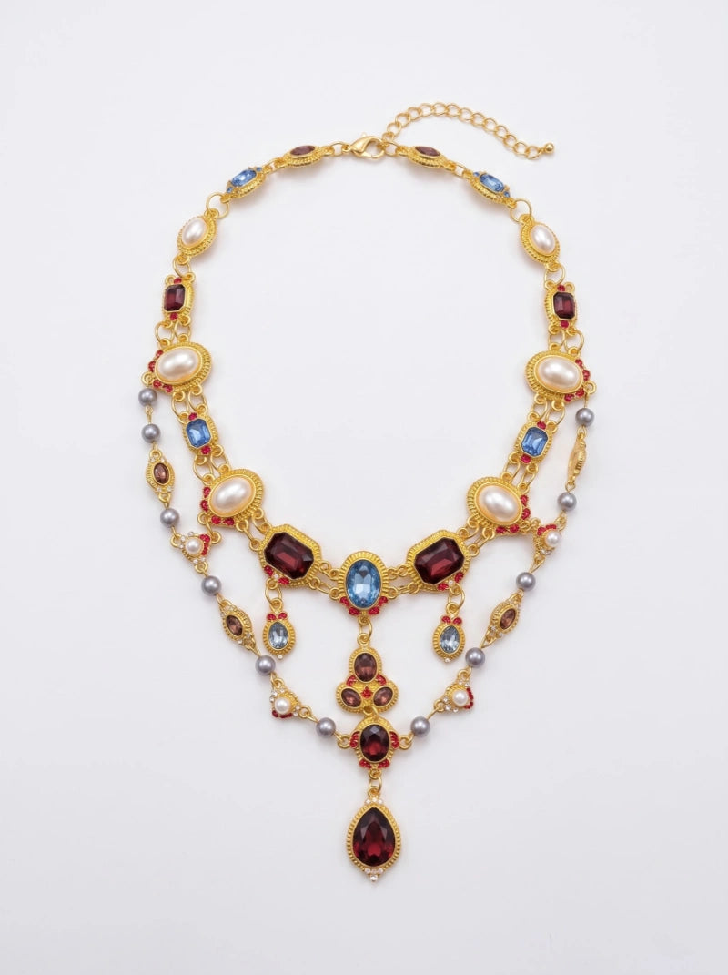 < img src="https://www.berynea.com/" 
       alt="Baroque Multi-Gem Gold Statement Necklace | Royal Crystal Drop Jewelry" 
       loading="lazy" />